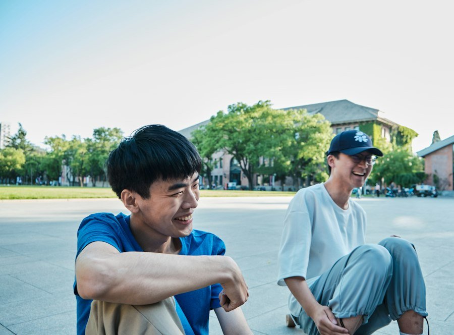 A young person laughing with a mentor outdoors