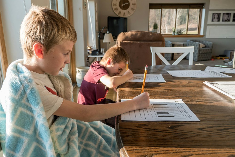 A pupil completing a worksheet at a table