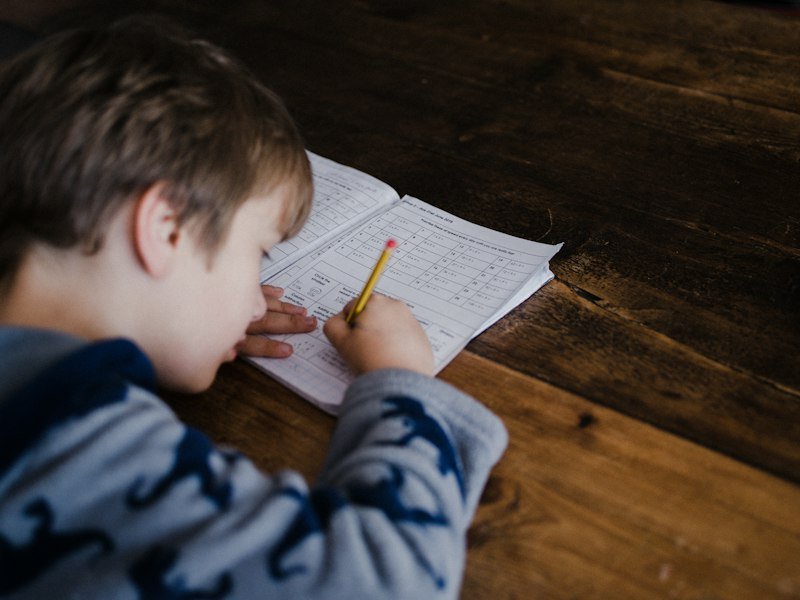 A pupil working through a maths worksheet